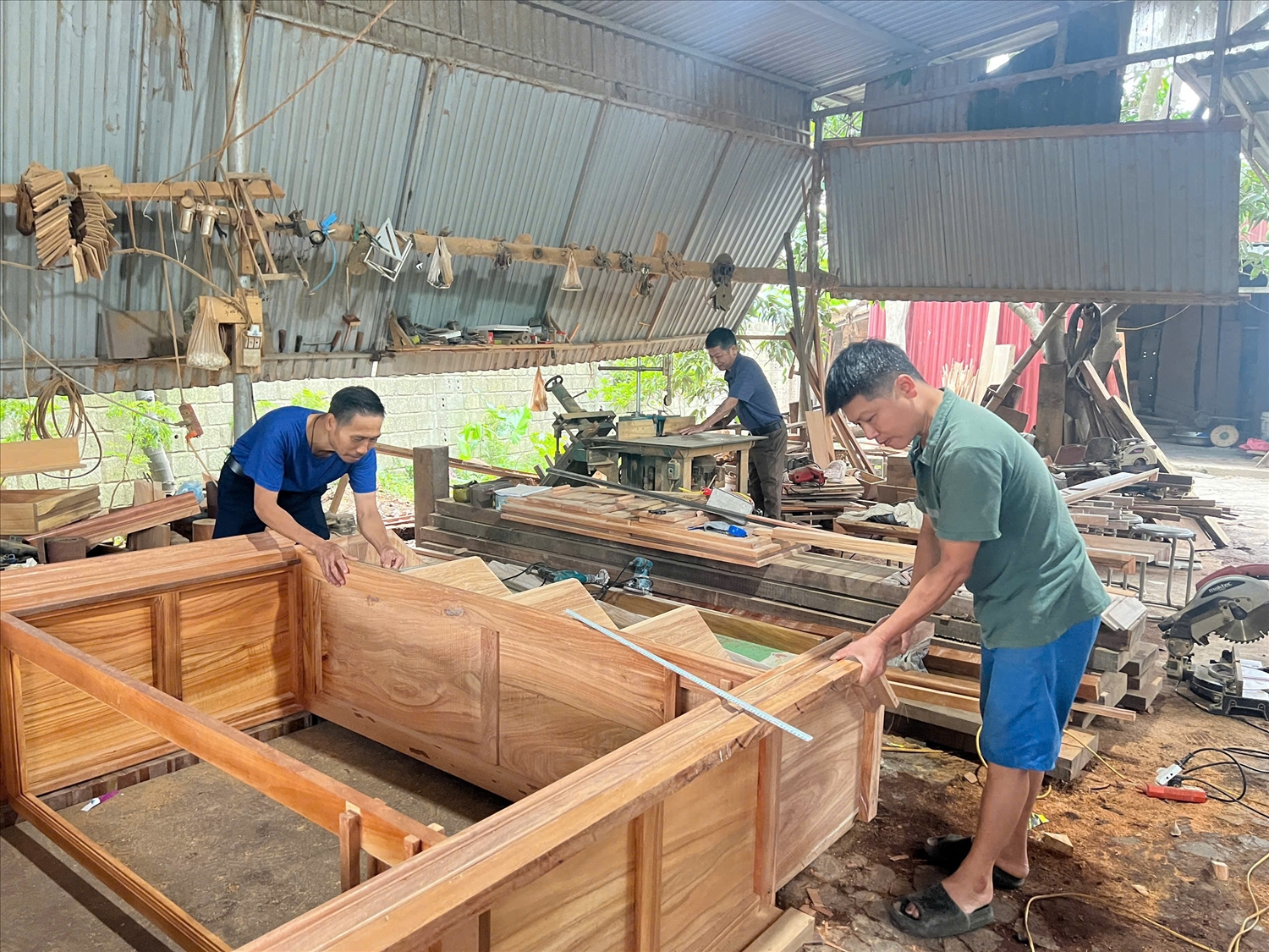 Lào Cai: Sức sống nghề mộc trong đời sống hiện đại 2 Anh Vũ Văn Hưng cùng các công nhân đang thực hiện các công đoạn hoàn thành tủ gỗ.