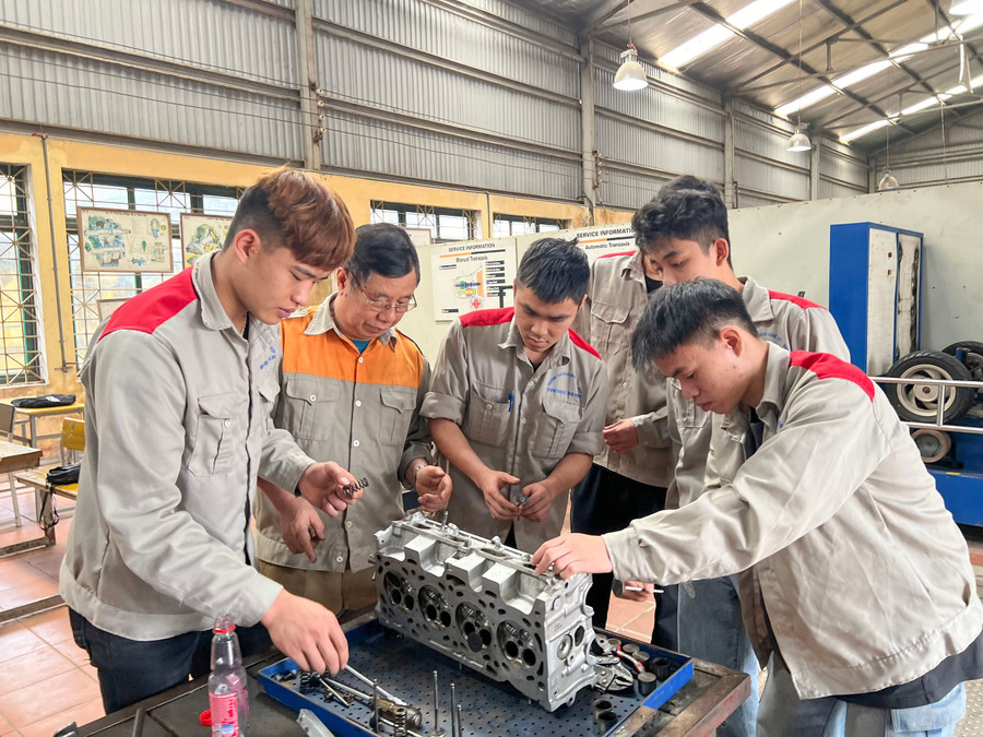 Giáo viên và học sinh lớp trung cấp nghề ô tô, Trường Cao đẳng nghề số 1 - Bộ Quốc phòng trong giờ thực hành.