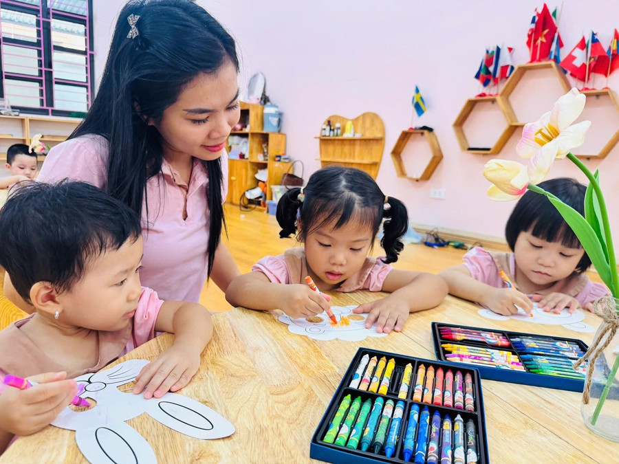 Giáo viên hướng dẫn trẻ tô màu tại Trường Mầm non 8/3 (Nam Định, Ninh Bình). 
