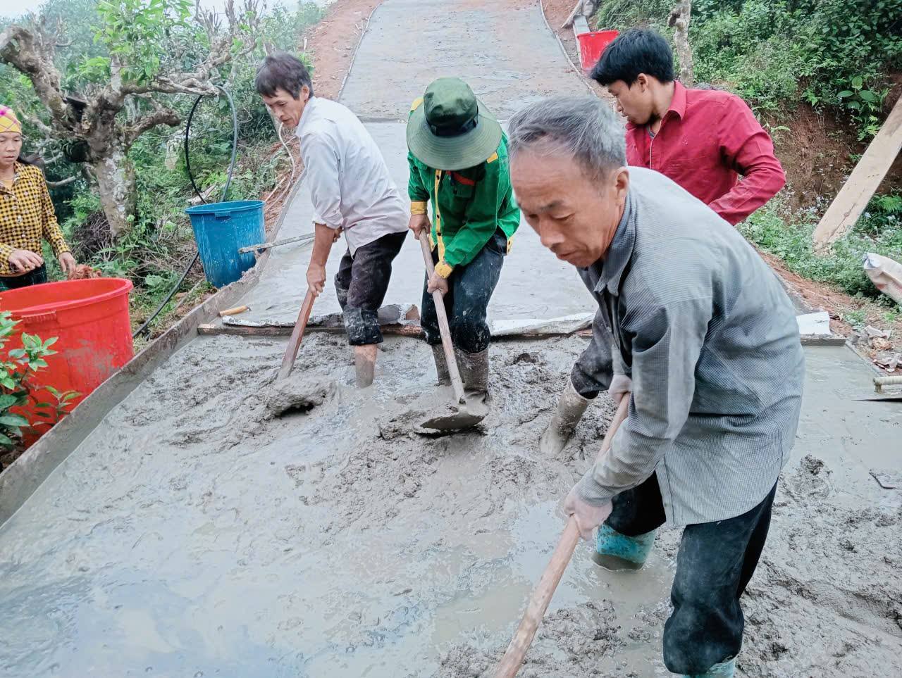 Bà con chung sức đổ bê tông, hoàn thiện đoạn đường trong bản.