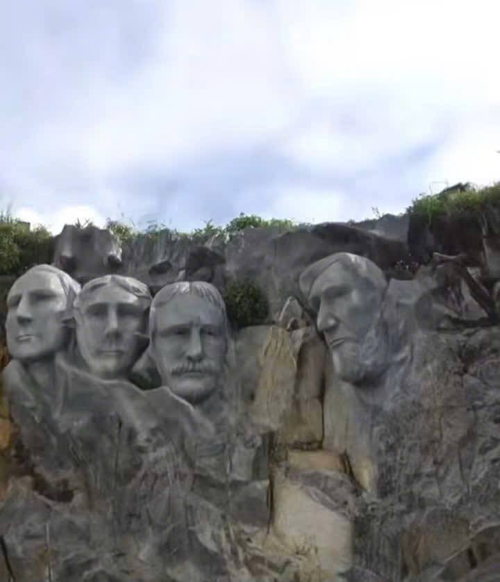 Vách đá được điêu khắc thành bốn khuôn mặt mô phỏng phong cách tượng đài Mount Rushmore.